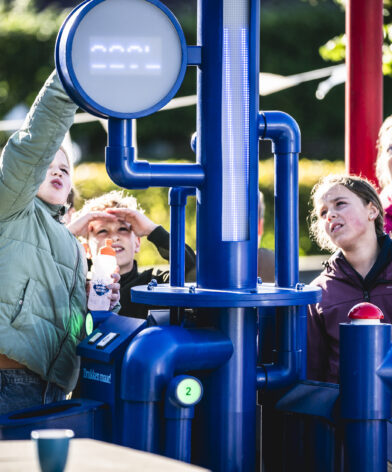 Kinderen spelen met waterwinmachine